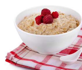 Tasty oatmeal with berries on napkin isolated on white