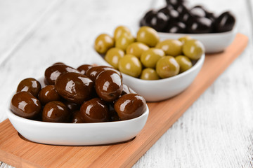 Different marinated olives on table close-up