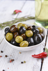Different marinated olives on table close-up