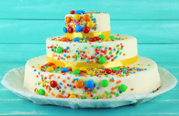 Fototapeta na wymiar Beautiful tasty birthday cake on color wooden background
