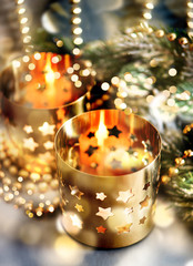 christmas decoration with candles, lanterns and golden lights