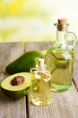 Avocado oil on table on light background