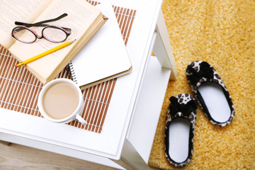 Still life details, cup of coffee, book and glasses