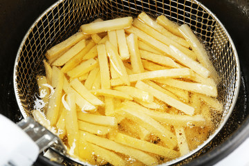 French fries in deep fryer, closeup