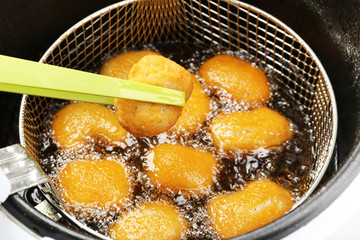 Cutlets in deep fryer, closeup