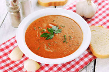 Delicious lentil cream-soup on table close-up