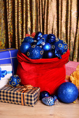 Red bag with Christmas toys and gifts on fabric background