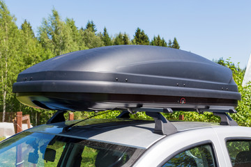 Car with roof rack with cargo box