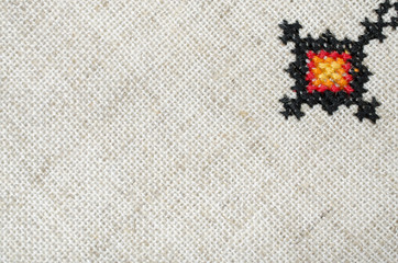 multicolored embroidered element on linen cotton threads