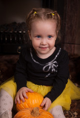 beautiful little girl with pumpkin