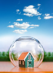 Insured house under glass sphere