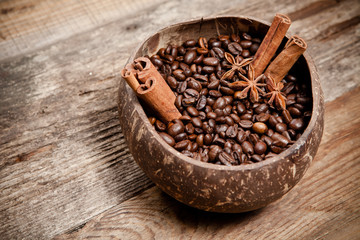 Coffee cup with coffee beans on wooden table