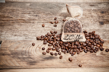 Coffee beans in bag on wooden table