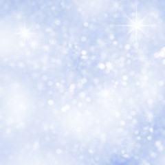 Abstract blue christmas snow background with defocused sparkles.