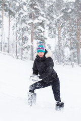 Fototapeta na wymiar Woman outdoors at winter forest