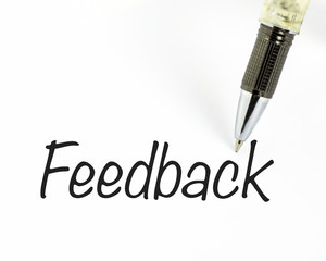Pen writes feedback word on paper - 71897667