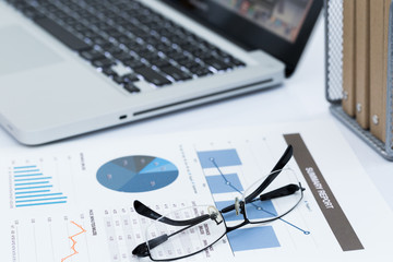 Naklejka na ściany i meble Analyzing investment charts with laptop. Accounting