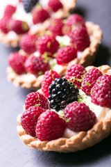 Delicious raspberry tarts on a stones board 