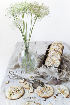 homemade cookies on box on white wooden table with wildflowers