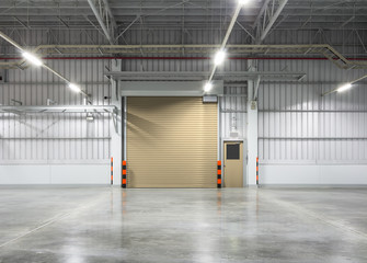 Roller door or roller shutter inside factory, warehouse or industrial building. Modern interior...
