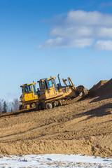 Yellow Excavator and bulldozer at Work in forest - obrazy, fototapety, plakaty