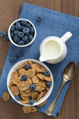 wholegrain flakes with blueberries and milk, top view