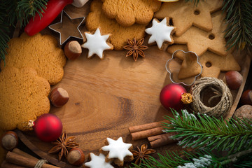 wooden background with Christmas cookies and ingredients
