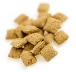 Macro of chicken cat biscuits against white