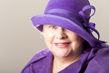 Close-up of white-haired woman in purple hat