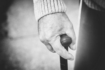 Closeup of old man hand with walking stick