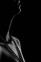 Woman's pearl passion isolated black bacground