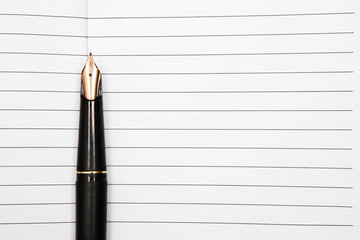 Fountain pen on an opened notepad