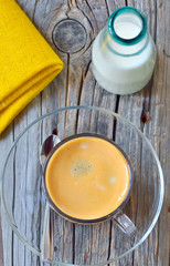 Cup of espresso and milk on old wood