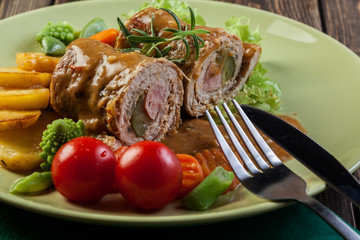 Pork rolls with prepared potatoes and vegetables
