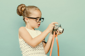 child holding a instant camera
