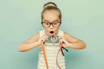 child holding a instant camera