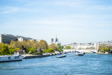 Canal of Paris with boats and trees with buildings