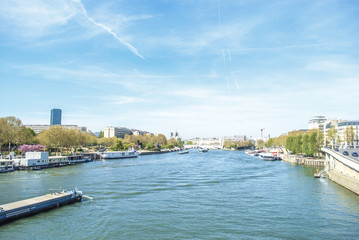 Naklejka premium Canal of Paris with boats and trees with buildings
