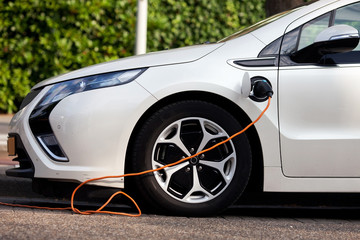 Electric car at the charging point. Green energy and zero emission theme 