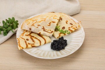 Pancakes with black caviar