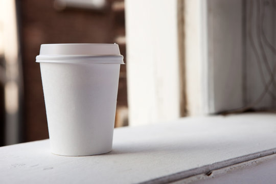 Disposable coffee cup on a window cill 