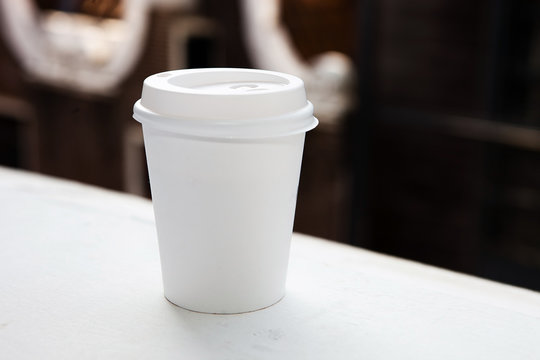 Disposable coffee cup on a window cill 
