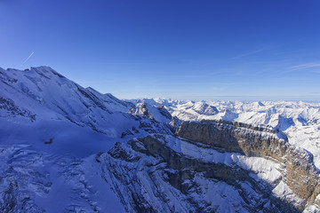 Fototapeta na wymiar Coomb, wall and peak in Jungfrau region helicopter view in winte