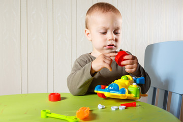 little boy repairs auto