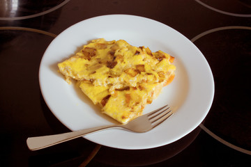 scrambled eggs with carrots and onions on a white plate