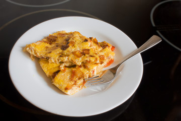 scrambled eggs with carrots and onions on a white plate