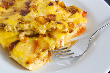 scrambled eggs with carrots and onions on a white plate