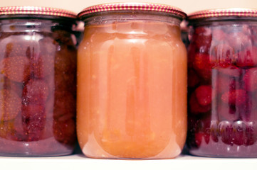 Various canning fruit jams in glass jars