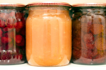 Various canning fruit jams in glass jars