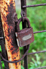 Rusty lock on rusty iron gate